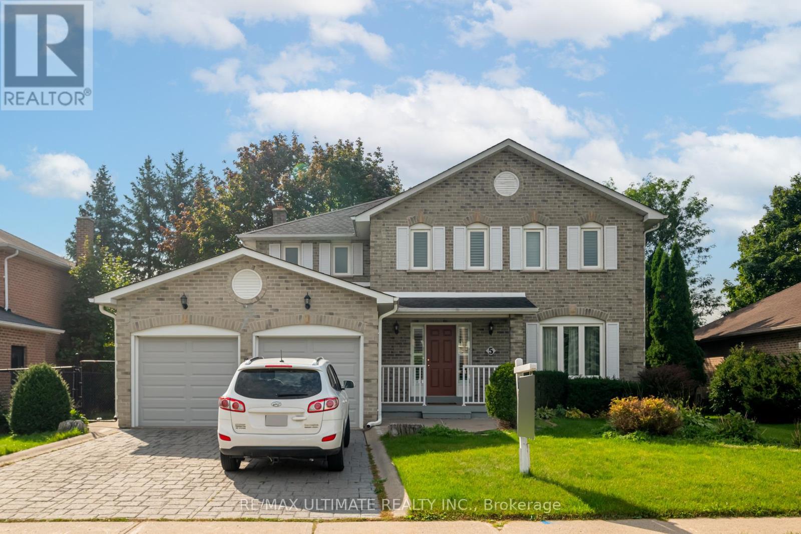 A house with a car parked in front of it.