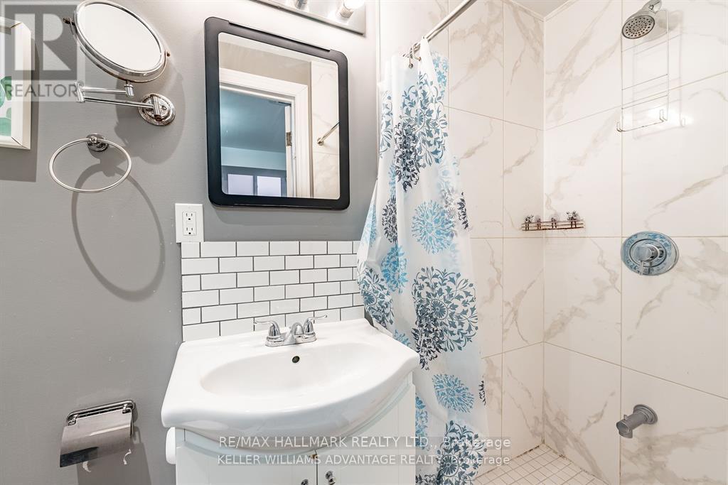 A bathroom with a white sink and a mirror.