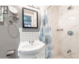 A bathroom with a white sink and a mirror.