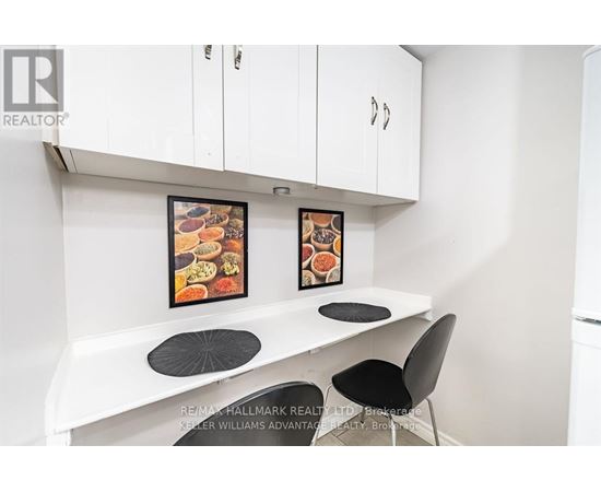 A white kitchen with a table and chairs.