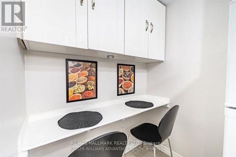 A white kitchen with a table and chairs.
