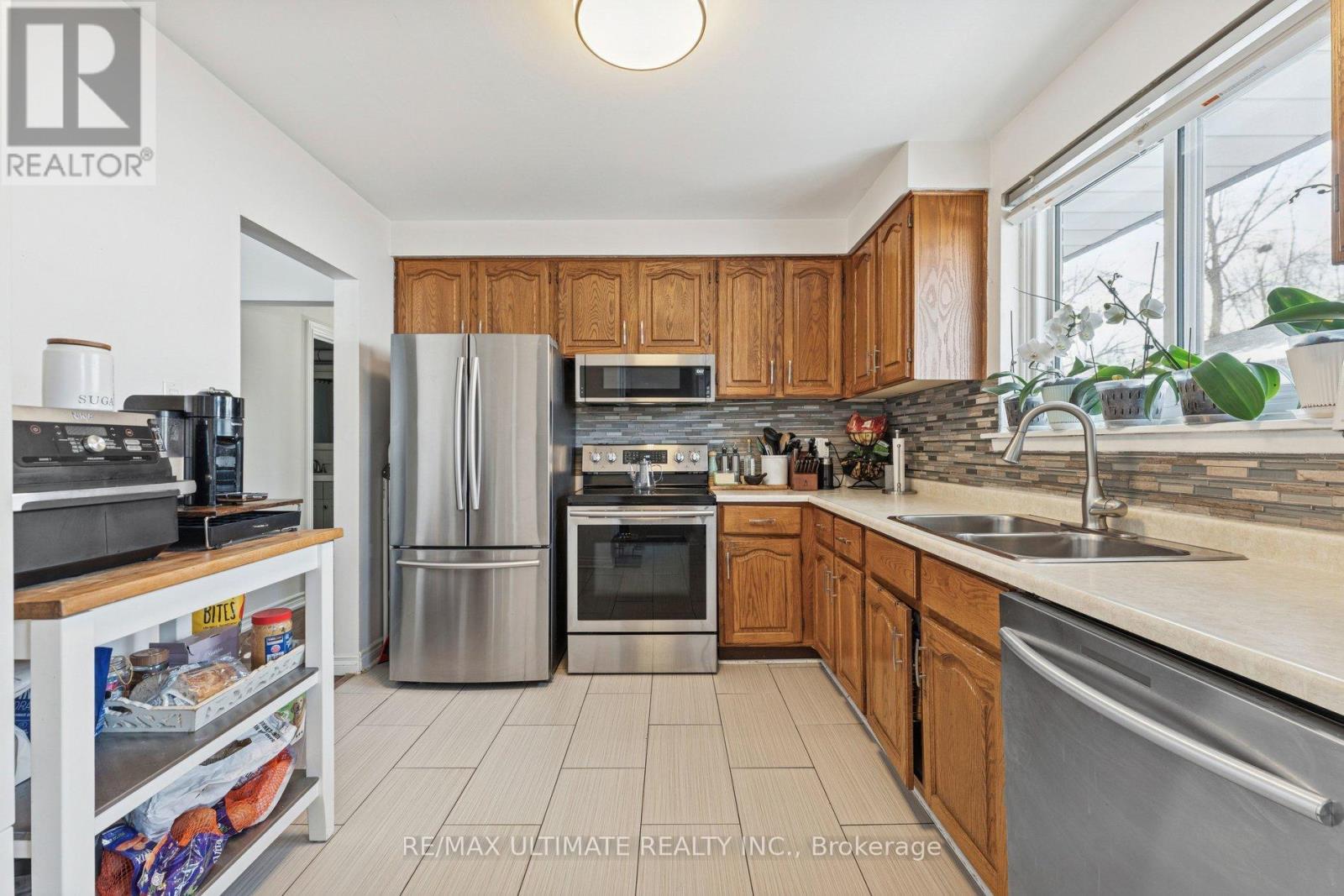 A kitchen with wooden cabinets and stainless steel appliances.