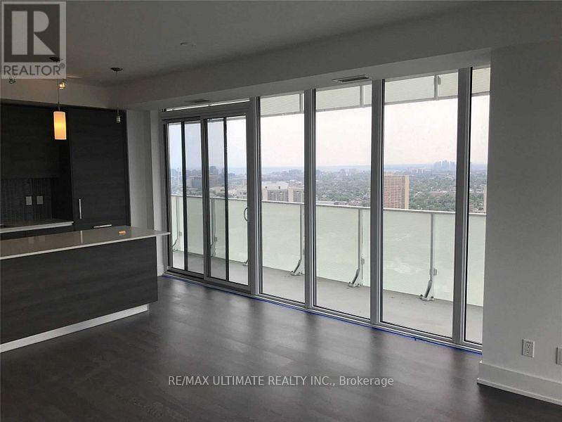 A room with a large window and a view of the city.