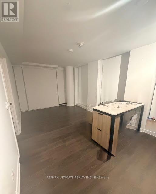 A room with a desk and a cabinet in it.