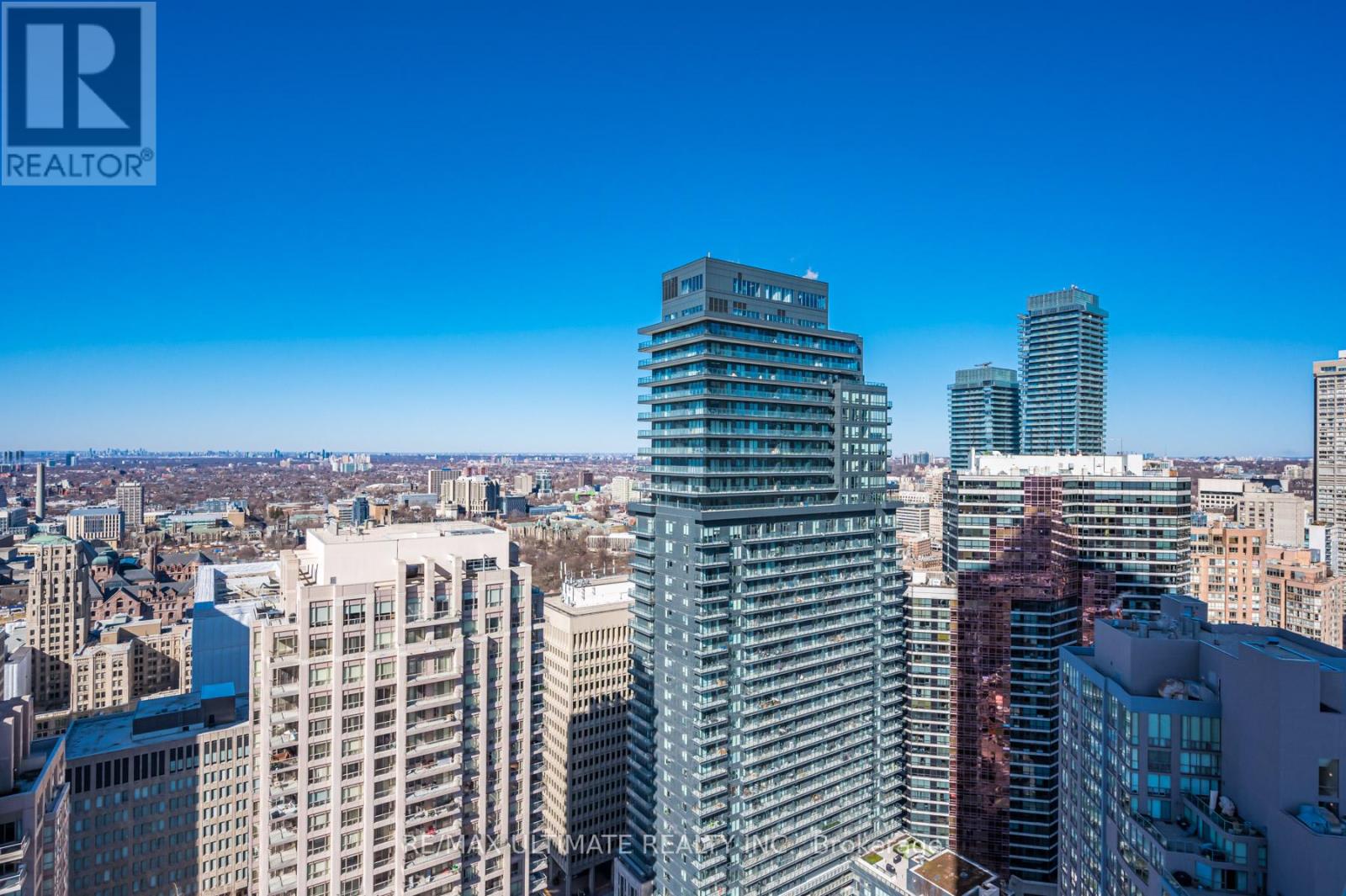 A cityscape with a tall building in the foreground and other buildings in the background.