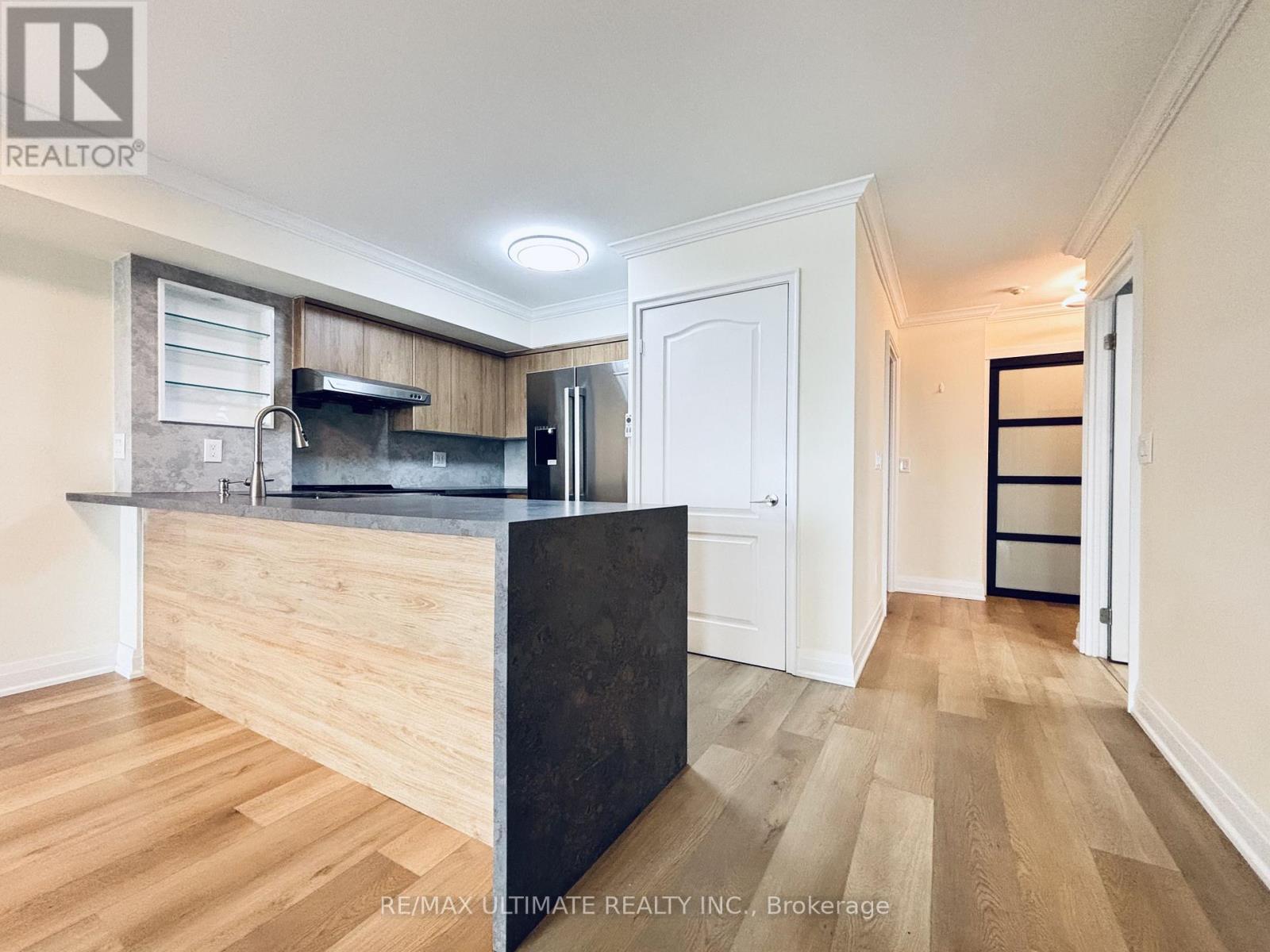 A kitchen area with a counter and cabinets.