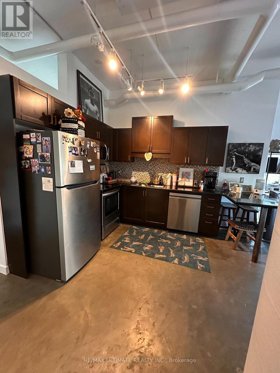 A kitchen with a refrigerator and a countertop.