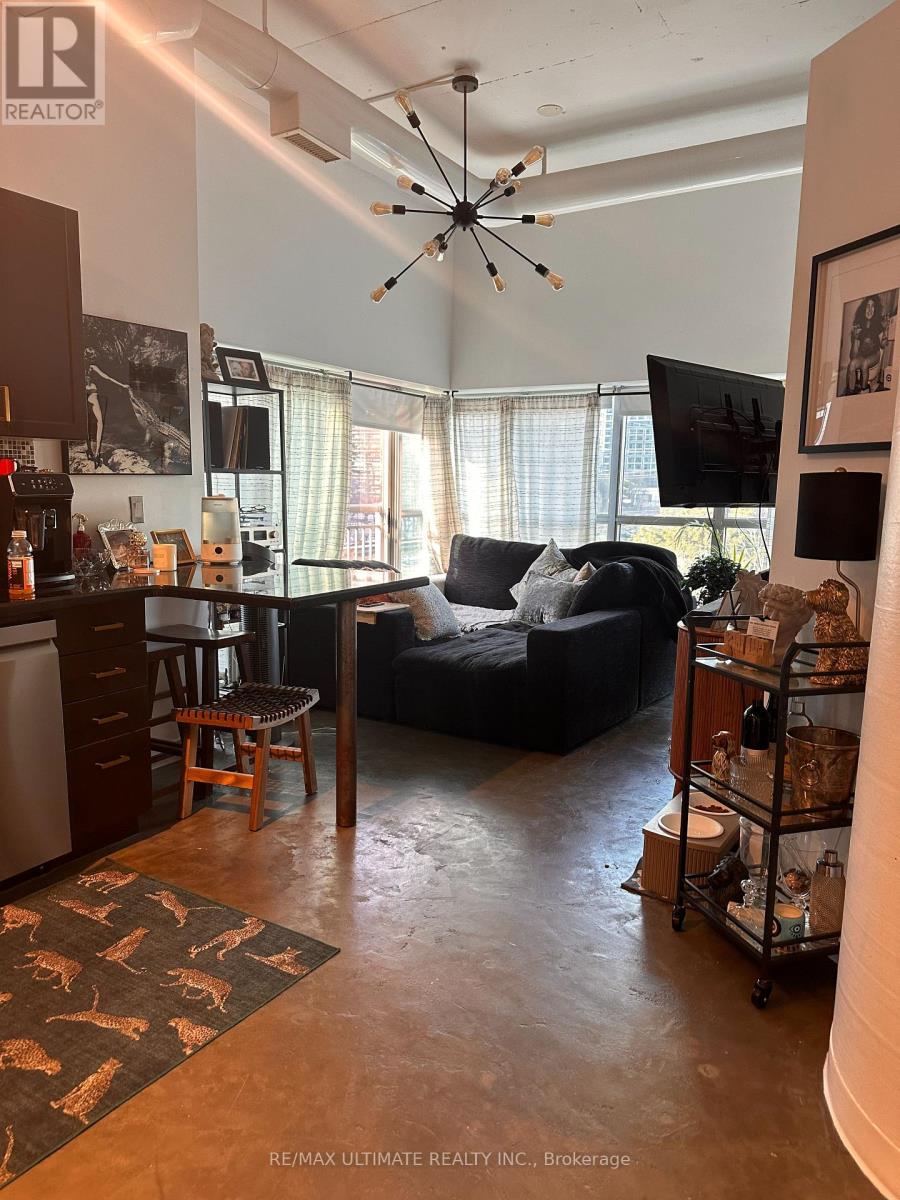 A living room with a couch, a chair, and a television.