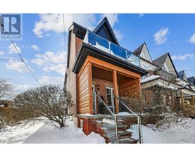 A house with a balcony is surrounded by snow.