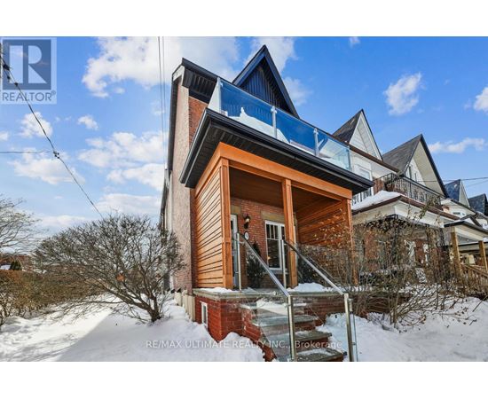 A house with a balcony is surrounded by snow.