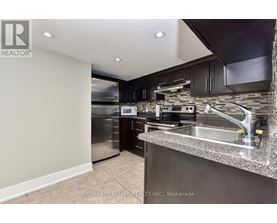 A modern kitchen with stainless steel appliances and a granite countertop.