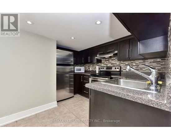 A modern kitchen with stainless steel appliances and a granite countertop.