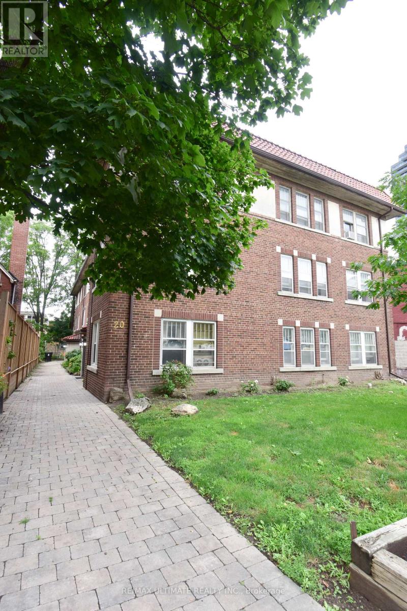 A red brick building with a walkway in front.