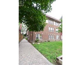 A red brick building with a walkway in front.