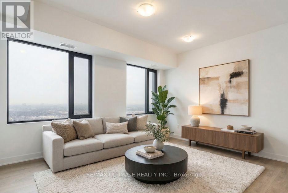 A living room with a large window, a sofa, a coffee table, and a painting on the wall.