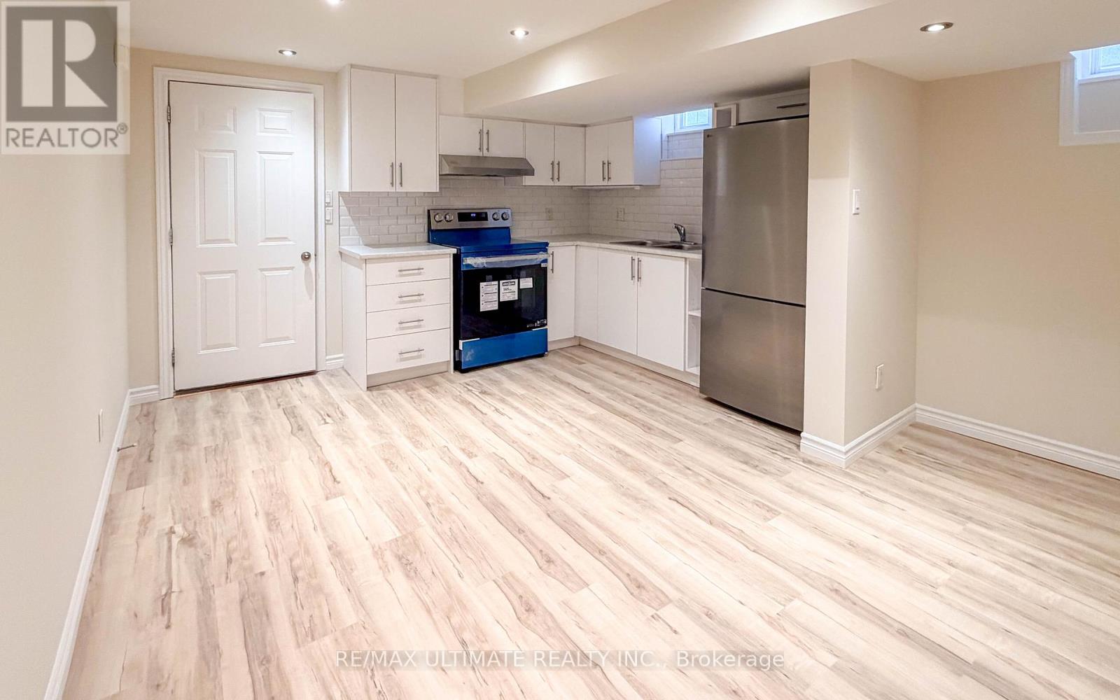 A kitchen with white cabinets and a blue box on the counter.