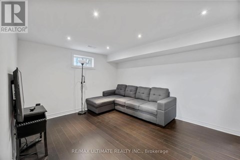 A living room with a grey sofa and a television.