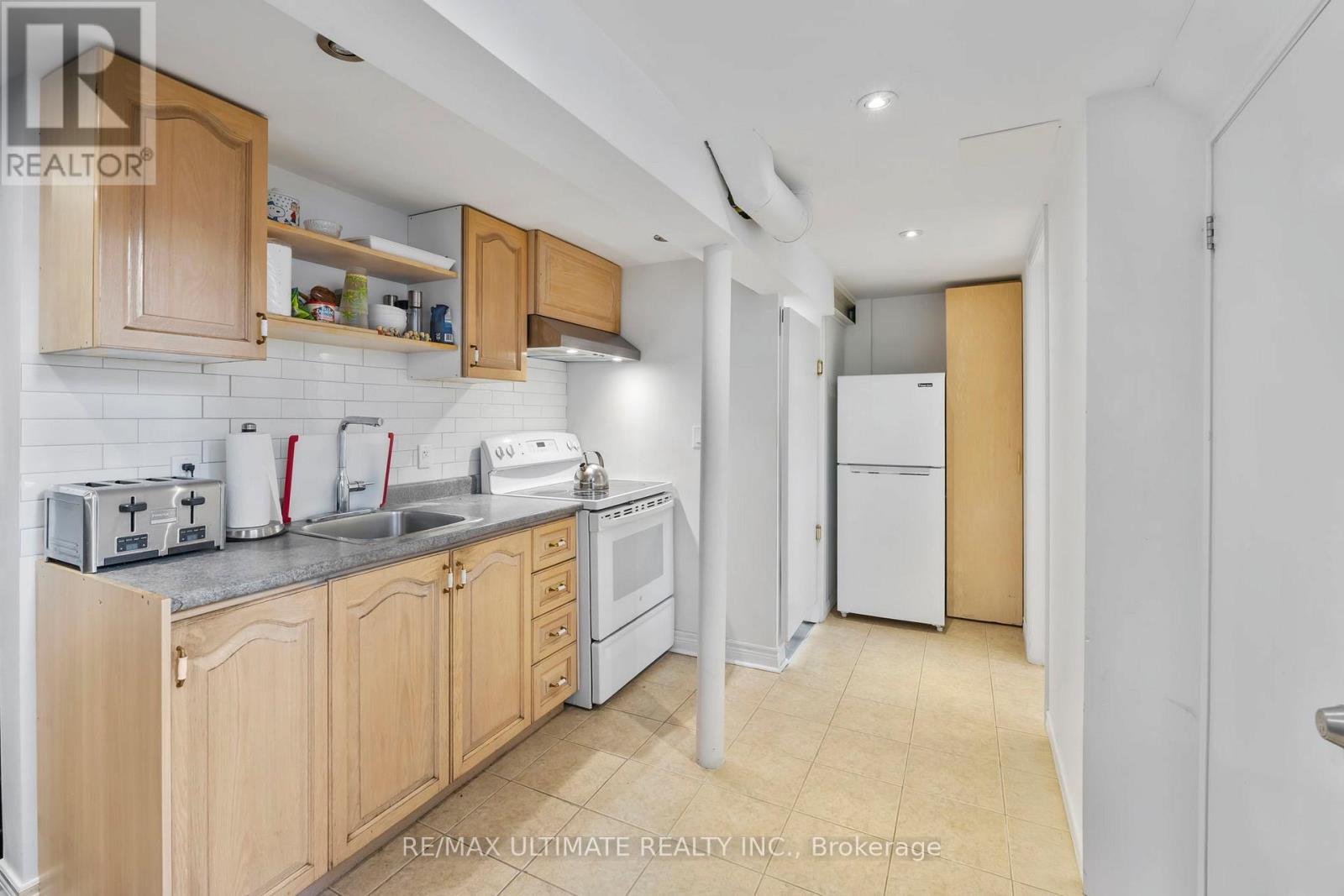 A kitchen with wooden cabinets and white appliances.
