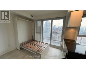 A bedroom with a large bed and a view of the city.