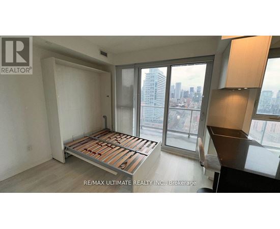 A bedroom with a large bed and a view of the city.