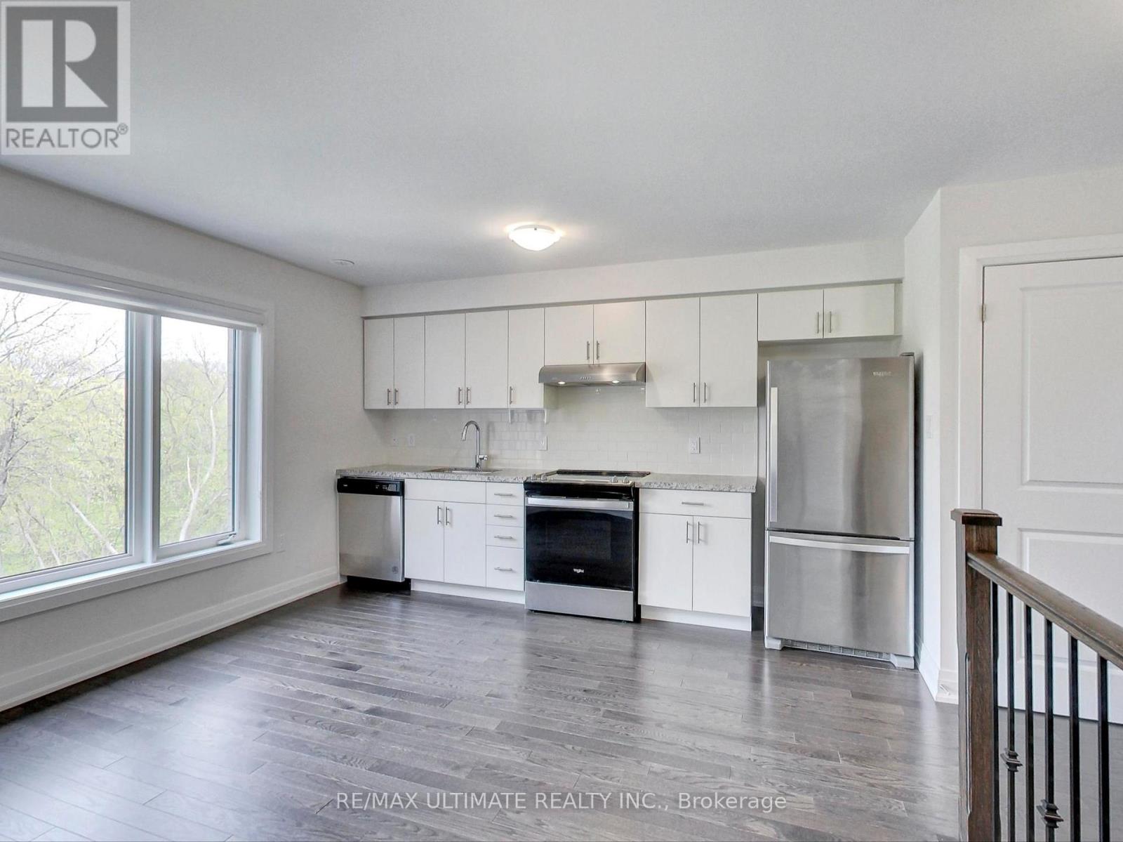 A kitchen with white cabinets and stainless steel appliances.