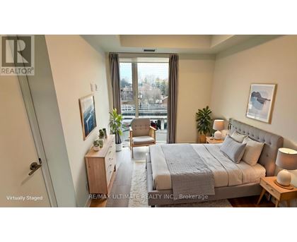 A bedroom with a large bed, a chair, and a window overlooking a cityscape.