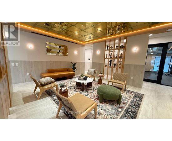 A living room with a sofa, chairs, and a rug.