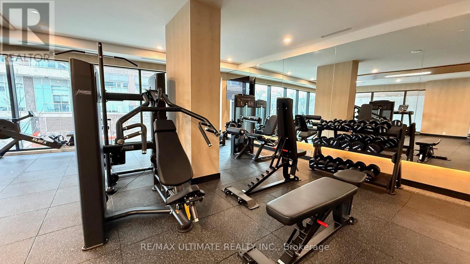 A gym with a variety of equipment including a leg press machine.