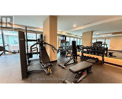 A gym with a variety of equipment including a leg press machine.