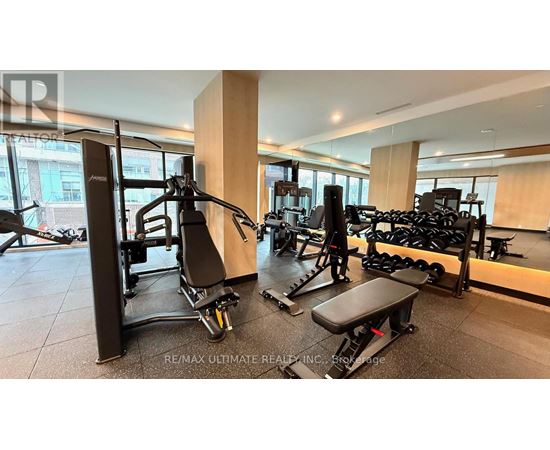 A gym with a variety of equipment including a leg press machine.