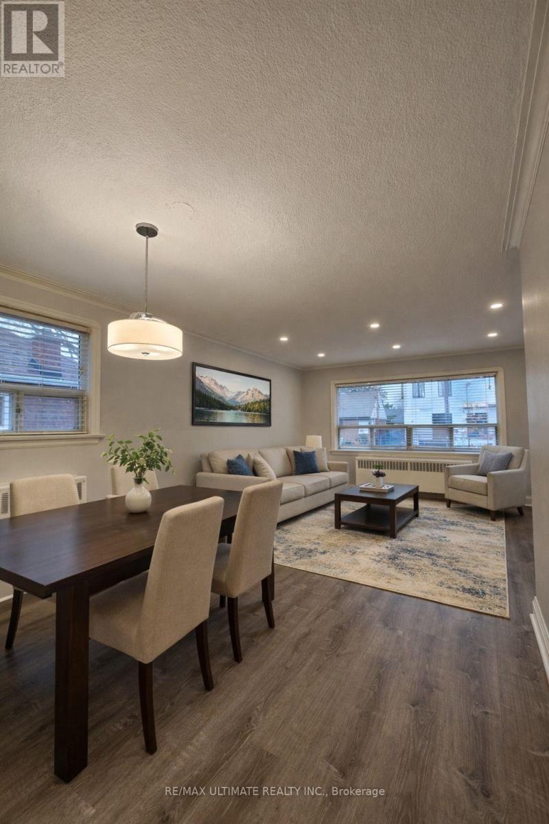 A dining room with a wooden table and chairs.