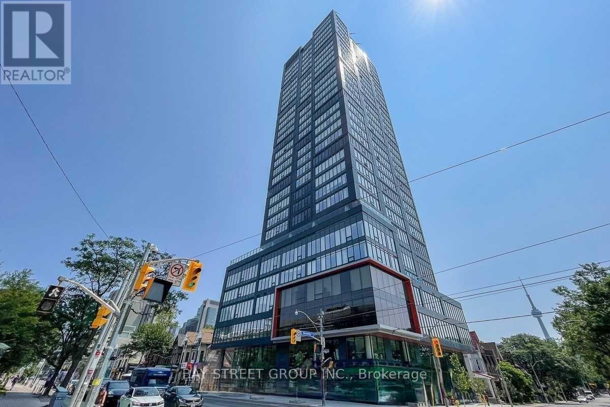 A tall building with a glass facade is the focal point of the image.