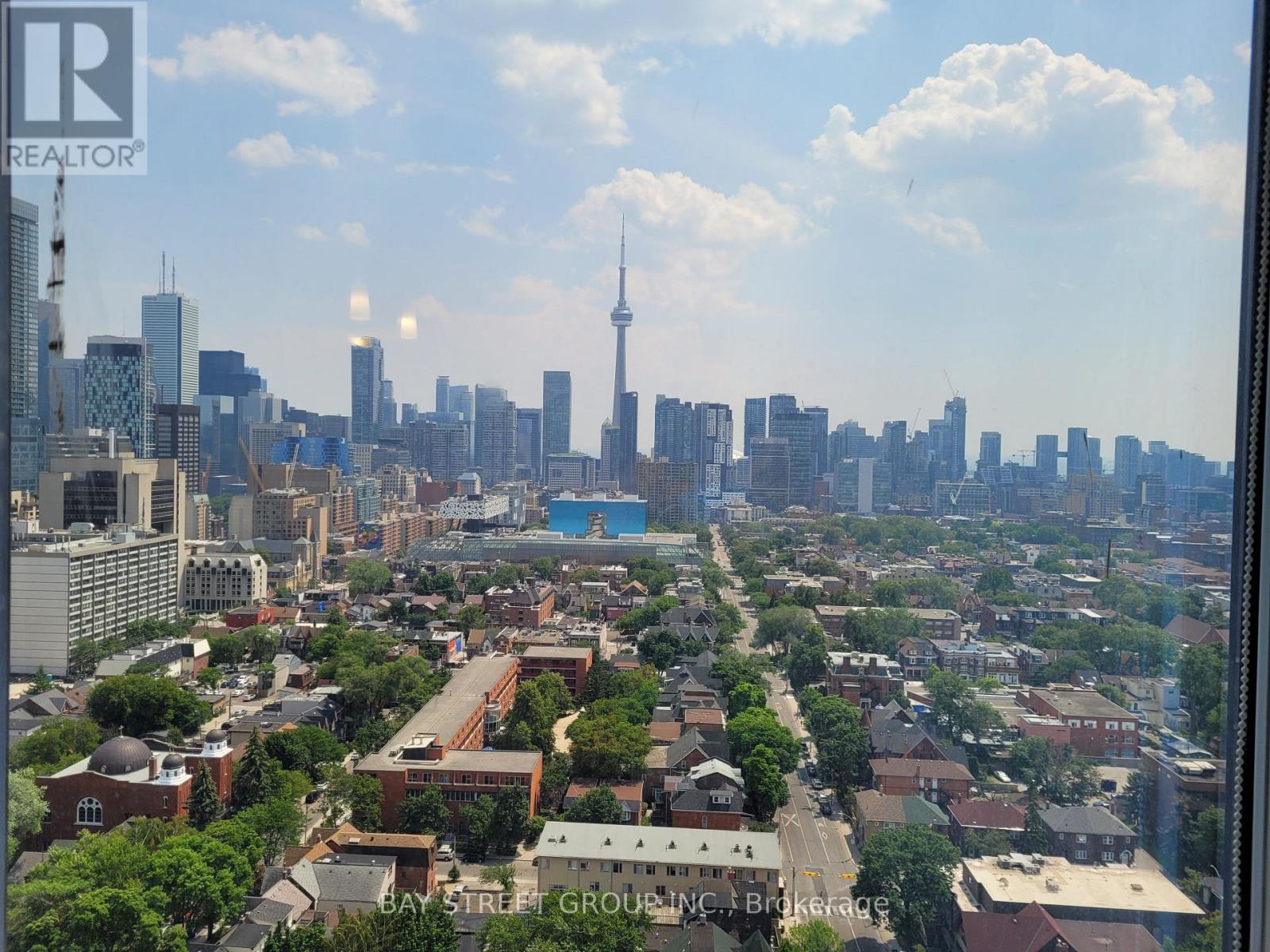 A cityscape with a mix of residential and commercial buildings, with a clear sky above.