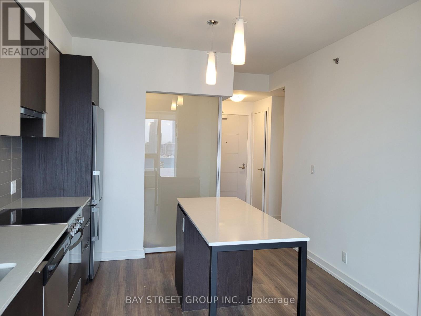 A kitchen with a table and chairs in the middle of the room.