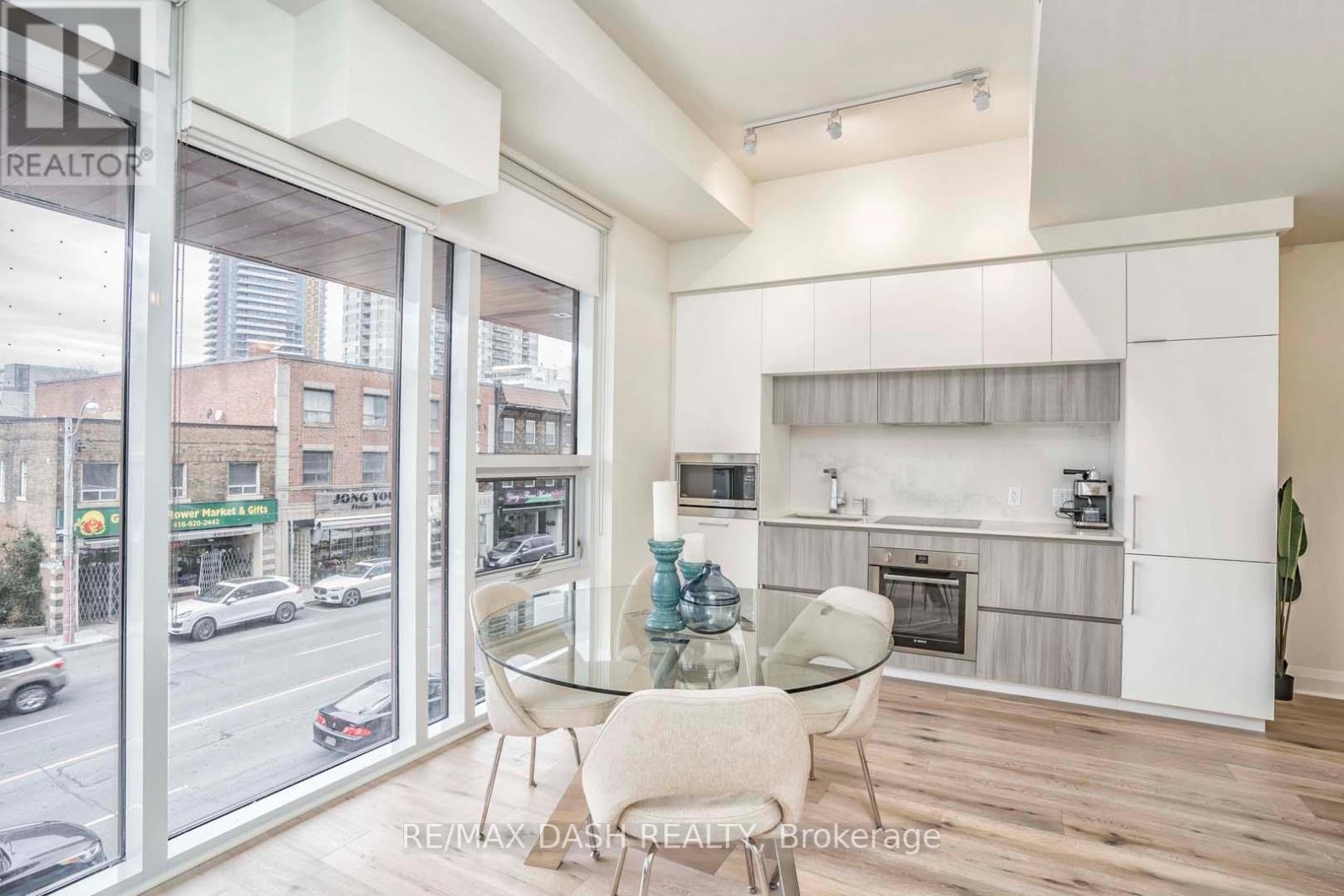 A modern kitchen with a glass table and chairs.