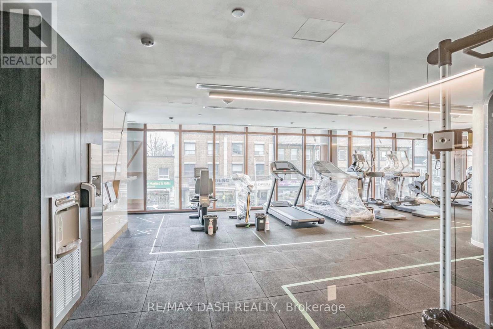 A spacious gym with treadmills, exercise bikes, and other equipment.