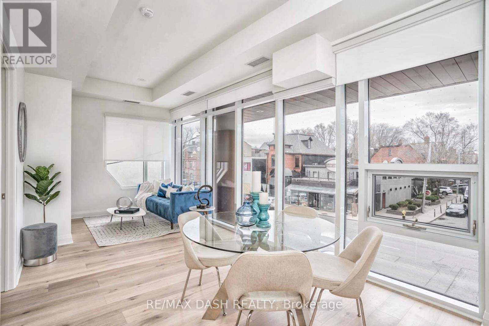 A modern living room with a glass table and chairs.