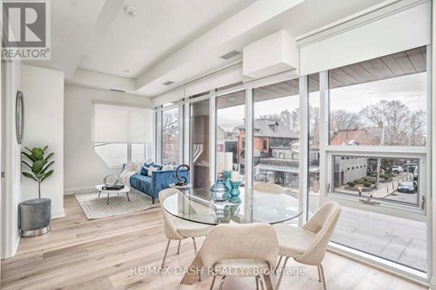 A modern living room with a glass table and chairs.