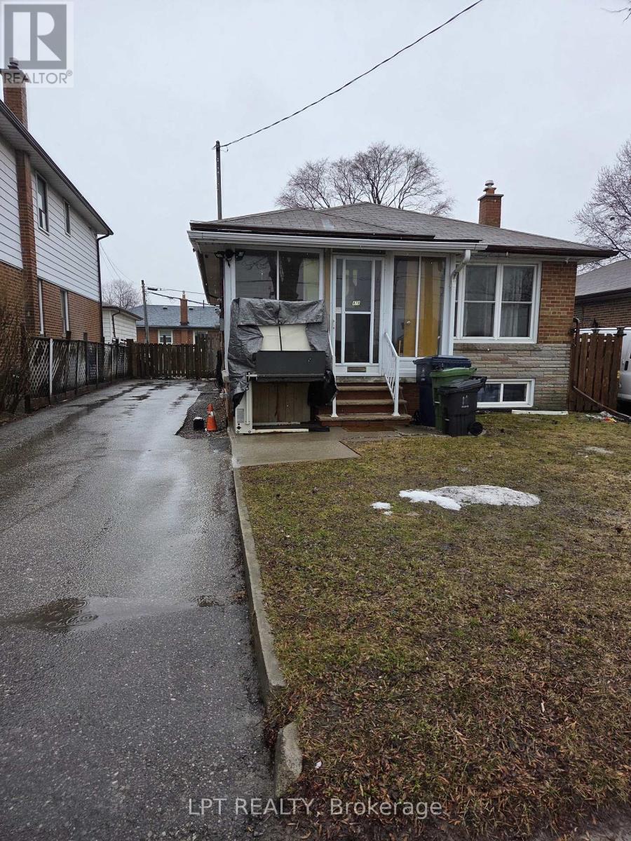 A house with a wet sidewalk in front of it.