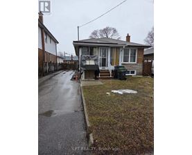 A house with a wet sidewalk in front of it.