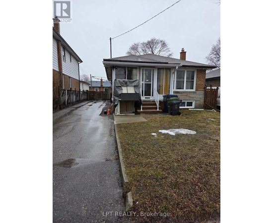 A house with a wet sidewalk in front of it.