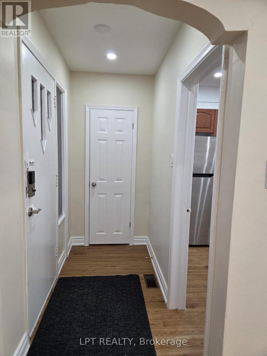 A hallway with a black doormat and white doors.