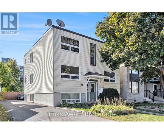 A house with a grey facade and a white door is for sale.
