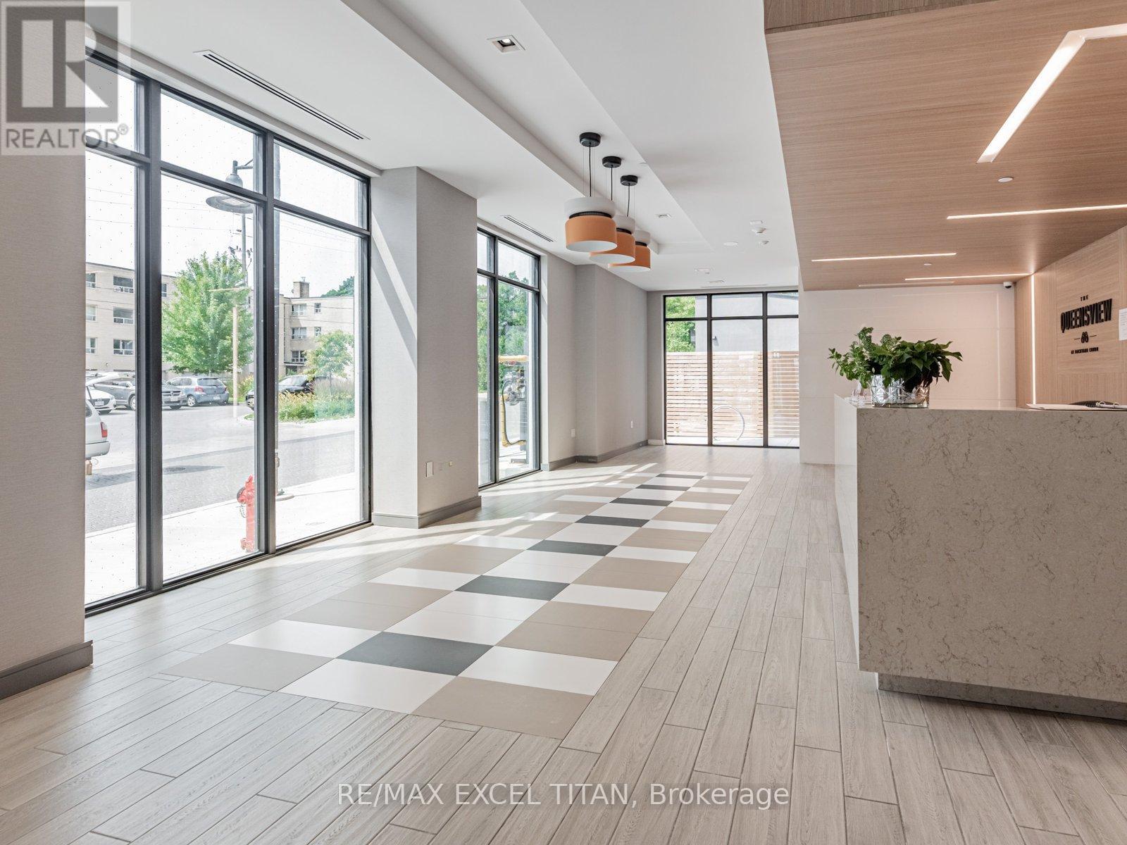 A spacious office lobby with a reception desk and large windows.