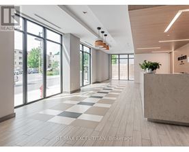 A spacious office lobby with a reception desk and large windows.