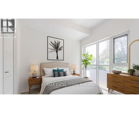 A bedroom with a large bed, a nightstand with a lamp, a dresser with a mirror, and a framed picture of a tree on the wall.