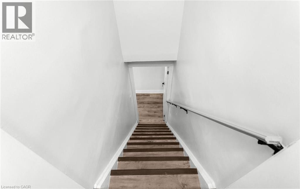 A staircase with wooden steps and white walls.
