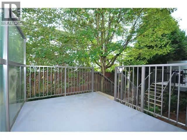 A backyard with a fence and a tree.