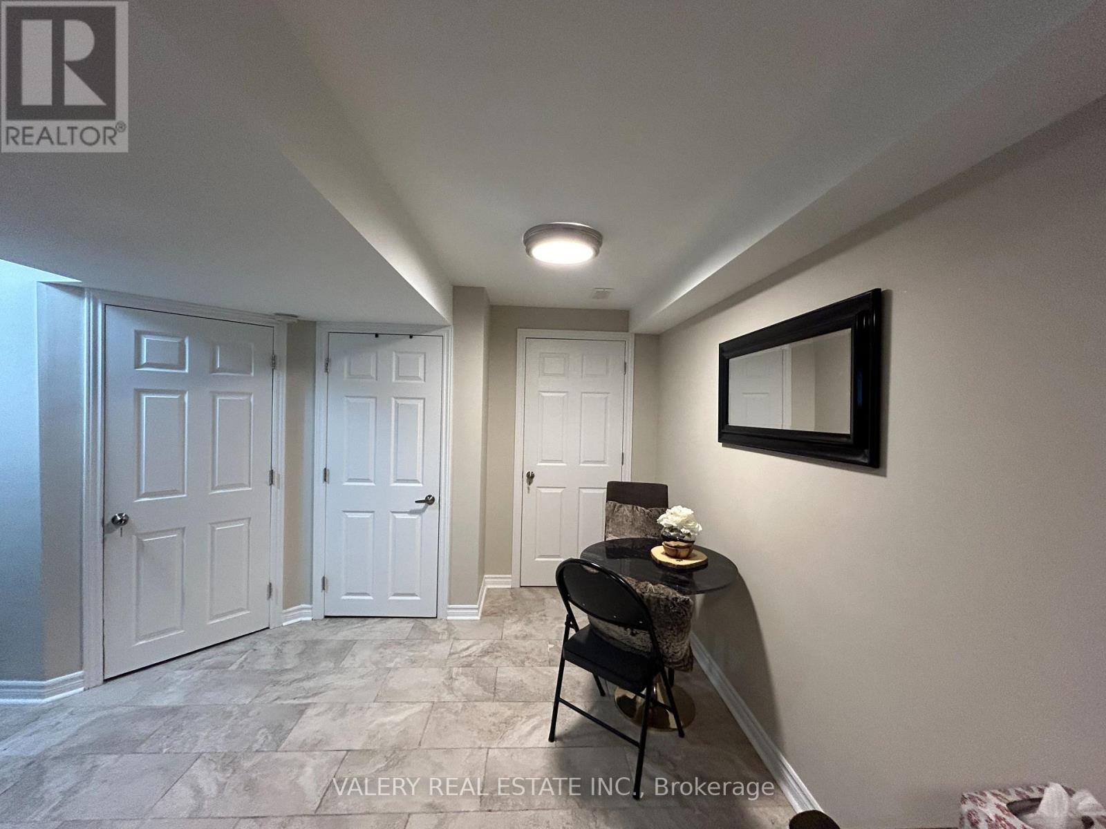 A room with a table and chairs in it.