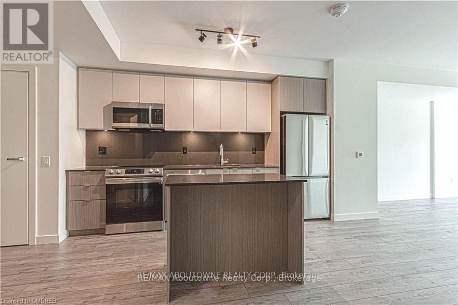 A modern kitchen with a stove top oven and microwave.